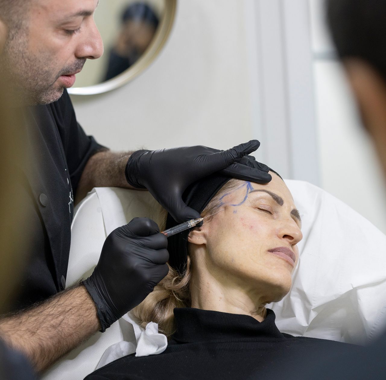 Healthcare professional demonstrating injection technique